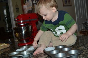 Davey lining the muffin pans.