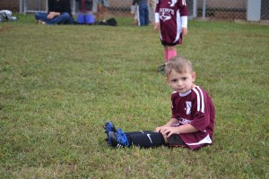 Sitting on the field.