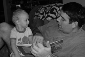 Reading with Daddy when he was 6 months old.