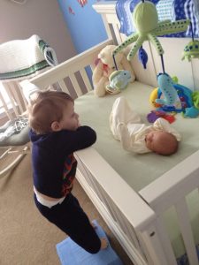 Watching over his baby brother.  